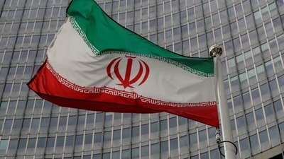 An Iranian flag flutters in front of the International Atomic Energy Agency (IAEA) headquarters in Vienna, Austria. (Reuters)