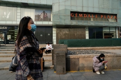 Residents wearing masks near a mall in Beijing on Nov. 21, 2023. (AP) Residents wearing masks near a mall in Beijing on Nov. 21, 2023. (AP)