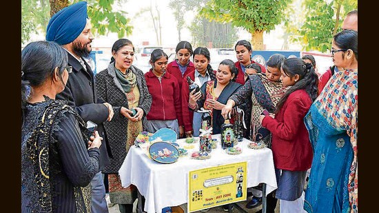 Students showcasing their art projects to parents during the mega PTM event organised at a government school in Ludhiana. (HT)