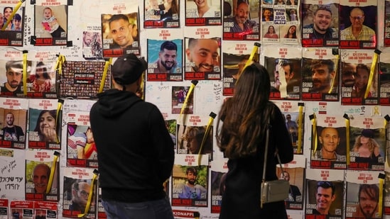 People look at portraits of Israeli hostages, held in Gaza since the October 7 attack, posted on a wall in Tel Aviv People look at portraits of Israeli hostages, held in Gaza since the October 7 attack, posted on a wall in Tel Aviv