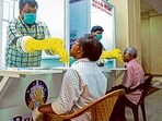 Medical staff collects samples for Covid-19 test at a walk-in kiosk in Kerala. Medical staff collects samples for Covid-19 test at a walk-in kiosk in Kerala.