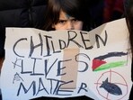 Sabina Fernandez, five, holds a banner during a demonstration to show support for Palestinians and solidarity with children in Gaza. REUTERS/Isabel Infantes 