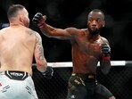 Dec 16, 2023; Las Vegas, Nevada, USA; Leon Edwards (red gloves) fights Colby Covington (blue gloves) during UFC 296 at T-Mobile Arena. Mandatory Credit: Stephen R. Sylvanie-USA TODAY Sports