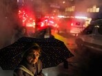 A woman walks under the rain in a street of Manhattan in New York city. A woman walks under the rain in a street of Manhattan in New York city.