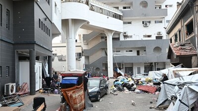 Israel-Hamas War: Palestinians gather outside one of the departments of the Al-Shifa hospital complex in Gaza City. (AFP) Israel-Hamas War: Palestinians gather outside one of the departments of the Al-Shifa hospital complex in Gaza City. (AFP)