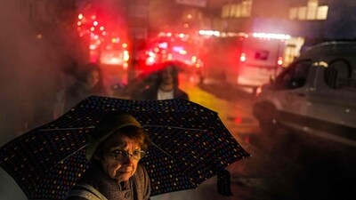 A woman walks under the rain in a street of Manhattan in New York city. (AFP) A woman walks under the rain in a street of Manhattan in New York city. (AFP)
