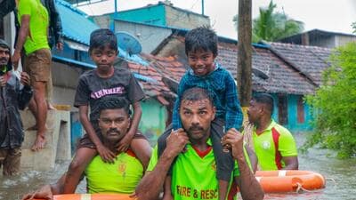 Tamil Nadu Fire and Rescue Services personnel rescue children from a flooded area after heavy rain, in Kanyakumari district on Sunday (PTI)