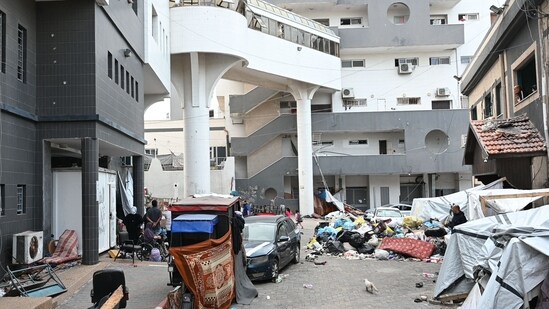 Israel-Hamas War: Palestinians gather outside one of the departments of the Al-Shifa hospital complex in Gaza City. (AFP)
