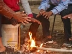 People huddle around a bonfire amid a foggy morning in New Delhi.