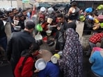 Palestinians collect free food handouts from a volunteer hospice in Rafah, southern Gaza, on Sunday, Dec. 17, 2023. More than 18,000�Palestinians�have been killed in Gaza since Israel retaliated after the Oct. 7 attack by Hamas militants with airstrikes and the ground assault, according to the health ministry in the Hamas-run enclave. Photographer: Ahmad Salem/Bloomberg