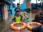 Tamil Nadu Fire and Rescue Services personnel rescue people from a flooded area after heavy rain, in Kanyakumari district,