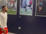 An adorable video shows Travis Kelce gazing at a photo of his girlfriend Taylor Swift before the Kansas City Chiefs vs. New England Patriots game (@NBCSCameraGuys screenshot/X)