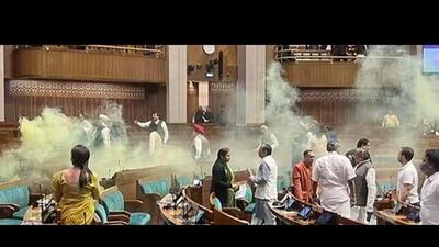 A video grab taken from the India TV channel shows an unidentified man jumping from the visitor’s gallery of Lok Sabha, using a smoke canister in the House during the Winter Session of Parliament, in New Delhi, last week. (ANI) A video grab taken from the India TV channel shows an unidentified man jumping from the visitor’s gallery of Lok Sabha, using a smoke canister in the House during the Winter Session of Parliament, in New Delhi, last week. (ANI)
