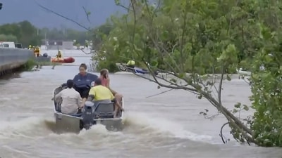 In this image from a video, people ride in boats in flooded river in Cairns, Australia on Monday. (AP) In this image from a video, people ride in boats in flooded river in Cairns, Australia on Monday. (AP)