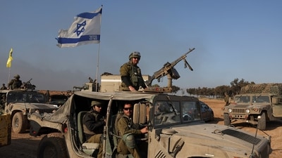 Israeli soldiers sit in a military vehicle, amid the ongoing conflict between Israel and the Palestinian Islamist group Hamas (REUTERS)