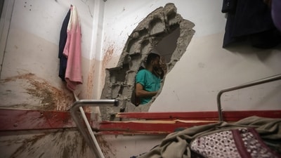 Palestinian paramedics inspect damage in the patient rooms caused by the Israeli strikes on the maternity ward at Nasser Hospital in the town of Khan Younis, southern Gaza Strip, on December 17. (AP) Palestinian paramedics inspect damage in the patient rooms caused by the Israeli strikes on the maternity ward at Nasser Hospital in the town of Khan Younis, southern Gaza Strip, on December 17. (AP)