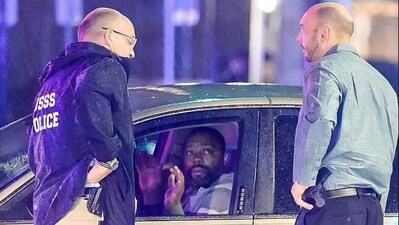 The car, a beige Ford, tried to continue into a closed-off intersection, before Secret Service personnel surrounded the vehicle with weapons and instructed the driver to put his hands up. The car, a beige Ford, tried to continue into a closed-off intersection, before Secret Service personnel surrounded the vehicle with weapons and instructed the driver to put his hands up.