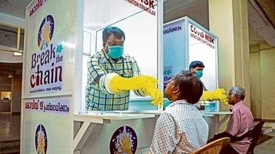 Medical staff collects samples for Covid-19 test at a walk-in kiosk in Kerala. (HT Photo)