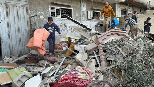 Palestinians inspect the site of an Israeli strike on a house in Khan Younis, amid the ongoing conflict between Israel and Palestinian group Hamas, in the southern Gaza Strip on  December 16, 2023. (REUTERS)
