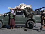 Afghanistan: Taliban fighters stand guard as they block a road near Kabul. Afghanistan: Taliban fighters stand guard as they block a road near Kabul.