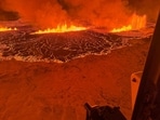 Billowing smoke and flowing lava turning the sky orange are seen in this Icelandic Coast Guard handout image during an volcanic eruption on the Reykjanes peninsula 3 km north of Grindavik, western Iceland on December 18, 2023. A volcanic eruption began on Monday night in Iceland, South of the capital Reykjavik, following an earthquake swarm, Iceland's Meteorological Office reported. 