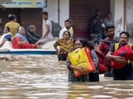People shift from a flooded road after heavy rainfall, in Thoothukudi district, Tamil Nadu on Dec. 19 People shift from a flooded road after heavy rainfall, in Thoothukudi district, Tamil Nadu on Dec. 19