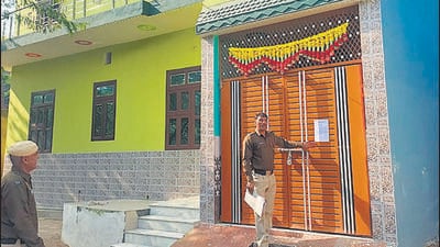 A police official pasting a notice on a house in Tauru. (HT photo) A police official pasting a notice on a house in Tauru. (HT photo)