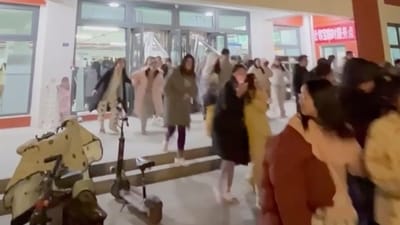 In this photo provided by Wang Xi, students evacuate from their dormitory at the Lanzhou University Yuzhong campus in Lanzhou in northwestern China's Gansu province Tuesday, after an earthquake hit the area. (AP)