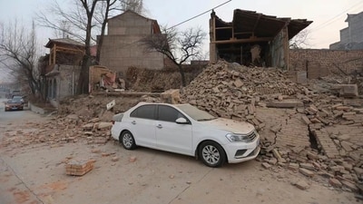 A vehicle is partially covered by a collapsed building in the aftermath of an earthquake in Dahejia village of Jishishan county in northwestern China's Gansu province on December 19. (AP) A vehicle is partially covered by a collapsed building in the aftermath of an earthquake in Dahejia village of Jishishan county in northwestern China's Gansu province on December 19. (AP)