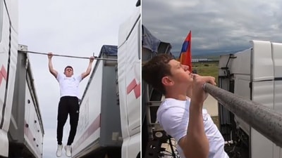 The image shows a teen creating a world record by performing pull-ups between moving trucks. (X/@GWR) The image shows a teen creating a world record by performing pull-ups between moving trucks. (X/@GWR)