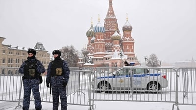 Police officers secures an area in front of Saint Basil's Cathedral on the snow-covered Red Square in Moscow. (AFP)