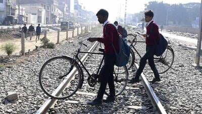 School students crossing the tracks amid the closure of the railway crossing in Model Town Block D, Ludhiana. (Manish/HT) School students crossing the tracks amid the closure of the railway crossing in Model Town Block D, Ludhiana. (Manish/HT)