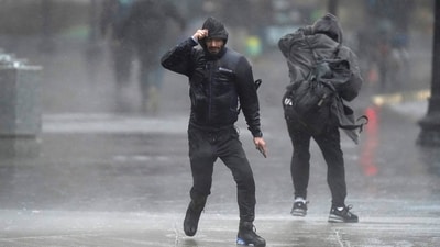 Pedestrians are buffeted by wind and rain as they cross a street, Monday, Dec. 18, 2023, in Boston. A storm moving up the East Coast brought heavy rain and high winds to the Northeast on Monday, threatening flooding, knocking out power to hundreds of thousands. (AP Photo/Steven Senne) (AP) Pedestrians are buffeted by wind and rain as they cross a street, Monday, Dec. 18, 2023, in Boston. A storm moving up the East Coast brought heavy rain and high winds to the Northeast on Monday, threatening flooding, knocking out power to hundreds of thousands. (AP Photo/Steven Senne) (AP)