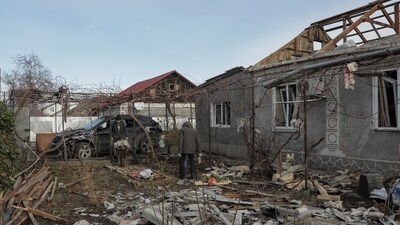 Local residents remove debris from the backyard of their house, which was damaged during a Russian drone strike, amid Russia's attack on Ukraine (REUTERS)