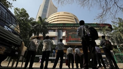 People look at a screen displaying the Sensex results on the facade of the Bombay Stock Exchange (BSE) building in Mumbai. (Reuters)