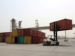 A forklift carries a shipping container at the Red Sea port of Hodeidah, Yemen.
