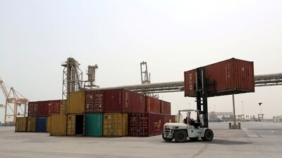 A forklift carries a shipping container at the Red Sea port of Hodeidah, Yemen. (Reuters)