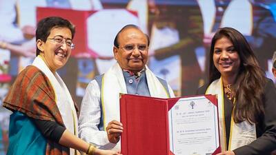 Delhi education minister Atishi with LG VK Saxena at the 12th convocation of Ambedkar University Delhi. (HT photo) Delhi education minister Atishi with LG VK Saxena at the 12th convocation of Ambedkar University Delhi. (HT photo)