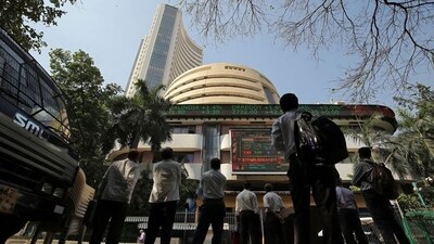 People look at a screen displaying the Sensex results on the facade of the Bombay Stock Exchange (BSE) building in Mumbai. (Reuters)