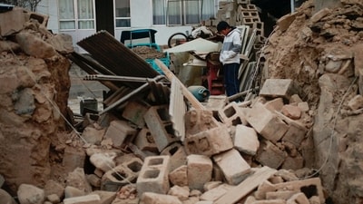 Gansu Earthquake: A boy stands amongst the rubble of his collapsed house in Dahejia in Jishishan County in northwest China's Gansu province. (AFP)