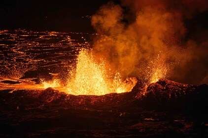 TOPSHOT - Molten lava is comming out from a fissure on the Reykjanes peninsula 3km north of the evacuate town of Grindavik, western Iceland on December 19, 2023. A volcanic eruption began on Monday night in Iceland, south of the capital Reykjavik, following an earthquake swarm, Iceland's Meteorological Office reported. (Photo by Kristinn Magnusson / AFP) / Iceland OUT (AFP) TOPSHOT - Molten lava is comming out from a fissure on the Reykjanes peninsula 3km north of the evacuate town of Grindavik, western Iceland on December 19, 2023. A volcanic eruption began on Monday night in Iceland, south of the capital Reykjavik, following an earthquake swarm, Iceland's Meteorological Office reported. (Photo by Kristinn Magnusson / AFP) / Iceland OUT (AFP)