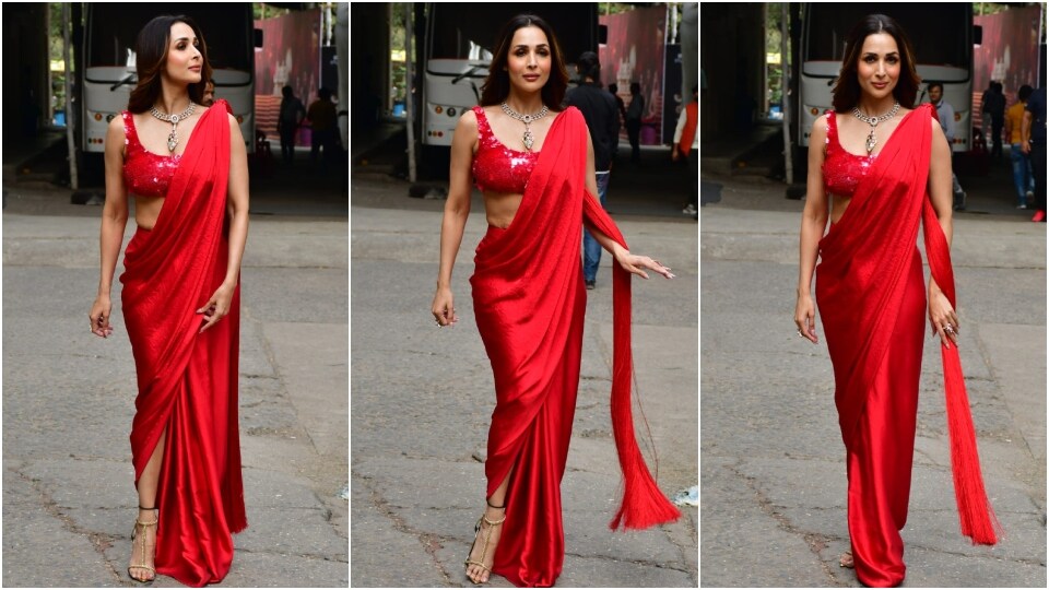 Malaika Arora poses for the paparazzi in a red thigh-slit saree. (HT Photo/Varinder Chawla)