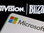 Microsoft logo is seen on a smartphone placed on displayed Activision Blizzard logo in this illustration taken January 18, 2022. (REUTERS/Dado Ruvic/Illustration//File Photo)