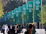 Delegates walk at the United Nations Climate Change Conference COP28 in Dubai, United Arab Emirates, December 8, 2023. (REUTERS)