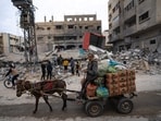 Palestinians inspect a house after it was hit by an Israeli bombardment on Rafah, southern Gaza Strip. (AP)