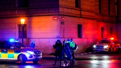 People walk near the building of Philosophical Faculty of Charles University in downtown Prague, Czech Republic. (AP)