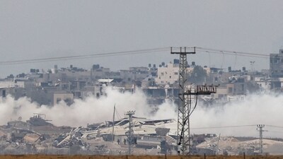 An Israeli military tank and soldiers operate in the Gaza Strip, amid the ongoing conflict between Israel and the Palestinian Islamist group Hamas, (REUTERS)