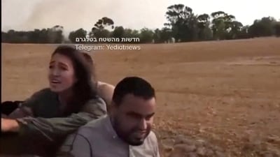 A screengrab from a social media video published on October 7, 2023 shows Noa Argamani as she is taken hostage by Palestinian militants, at an unknown location (Video obtained by Reuters/via REUTERS) (via REUTERS)