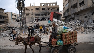 Palestinians inspect a house after it was hit by an Israeli bombardment on Rafah, southern Gaza Strip. (AP)