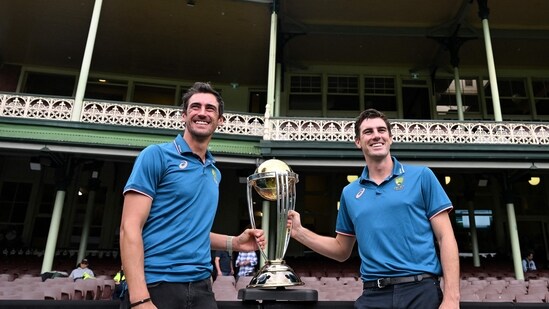 Australian cricketers Mitchell Starc (L) and team captain Pat Cummins pose with the ICC Men's Cricket World Cup 2023 Trophy during a media opportunity at the Sydney Cricket Ground on November 28, 2023 (AFP)